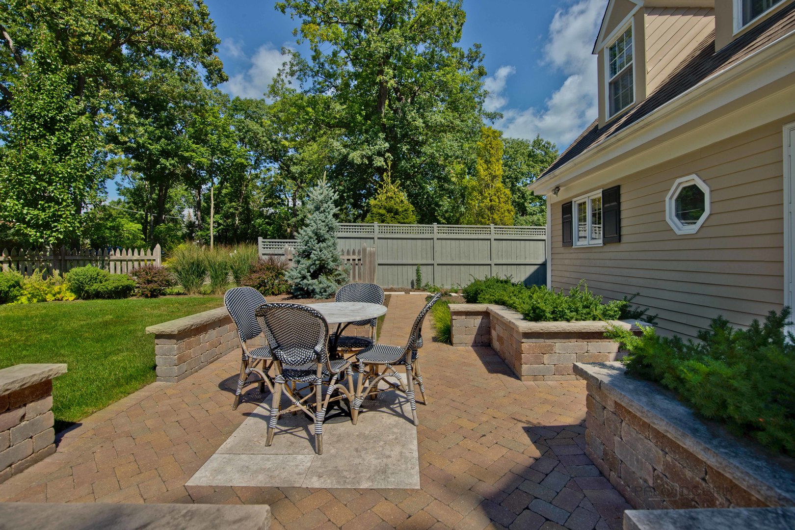 Undisclosed Address Lake Forest, IL 60045 - Photo 47 of 50 a view of a patio with table and chairs potted plants and a large tree