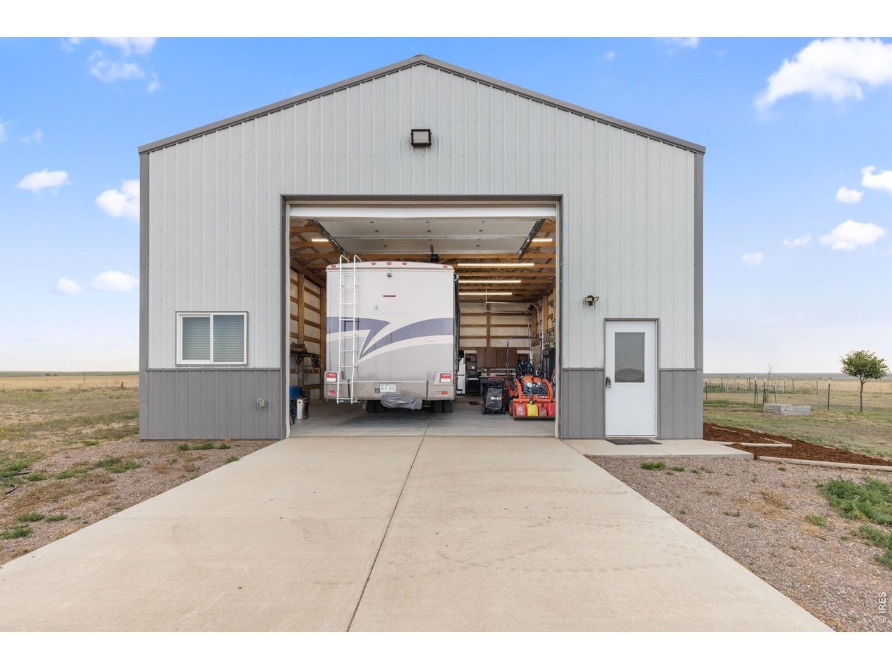 13550 Deter-Winters Road Byers, CO 80103 - Photo 10 of 50 The concrete driveway leading to the 14-foot overhead door supports heavy loads, prevents tire sinking and eliminates dust