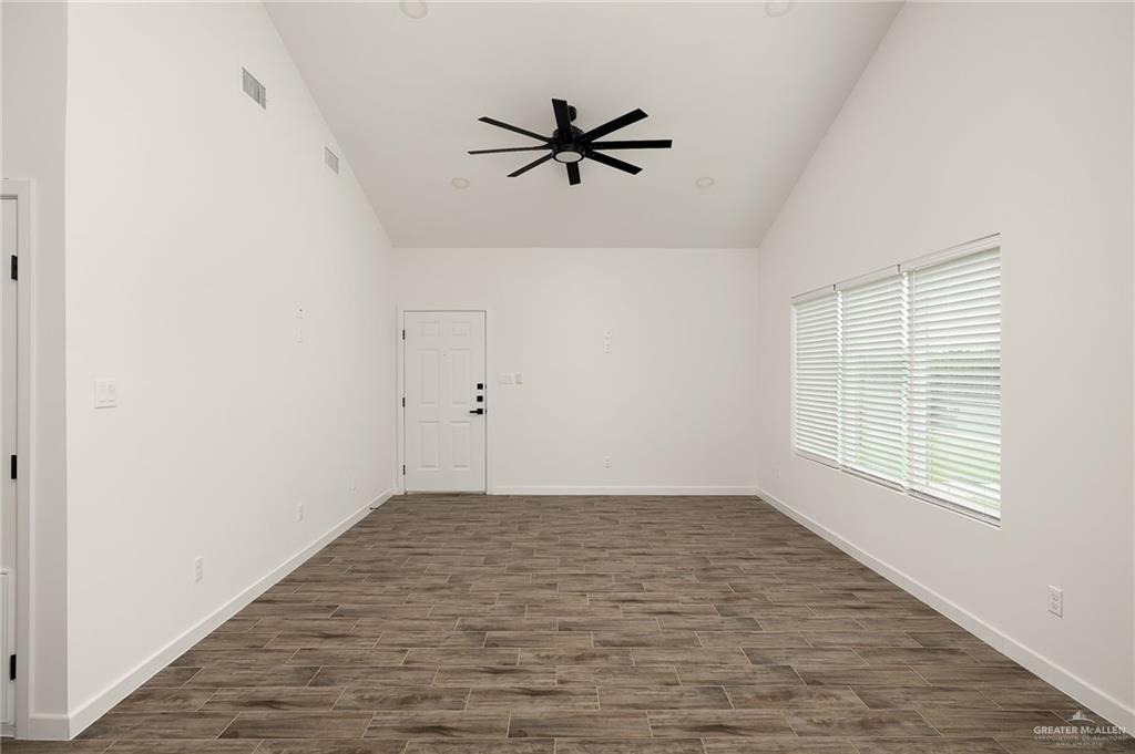 2608 Robin Road Weslaco, TX 78596 - Photo 3 of 14 wooden floor in an empty room with a window