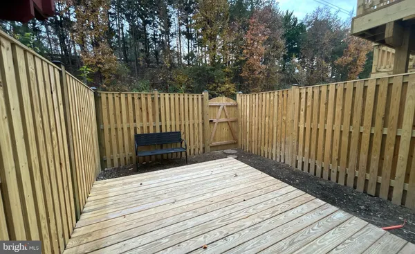 a view of backyard with a deck and wooden floor