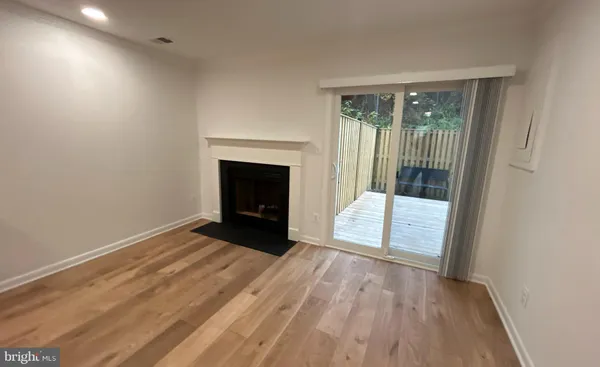 a view of an empty room and glass door