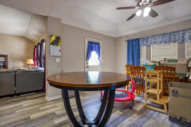 a living room with furniture and a book shelf