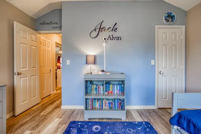a living room with furniture a rug and a floor to ceiling window