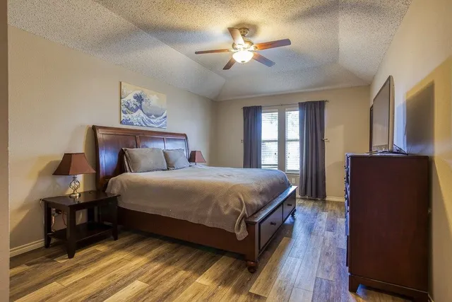 a room with a sink cabinets and wooden floor