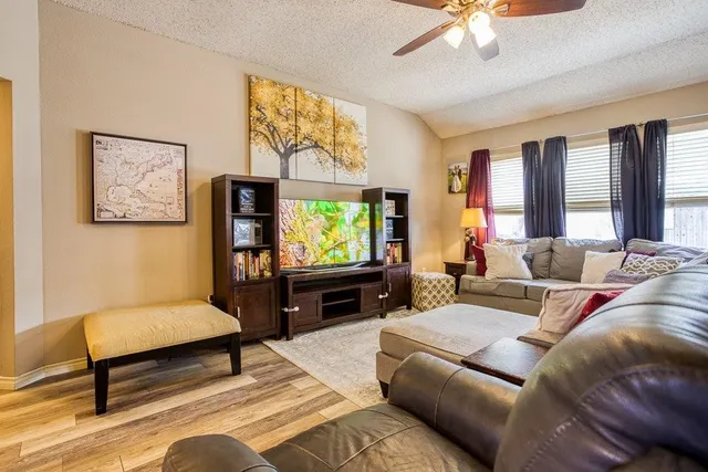 a living room with furniture and a flat screen tv