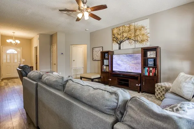 a living room with furniture and a flat screen tv