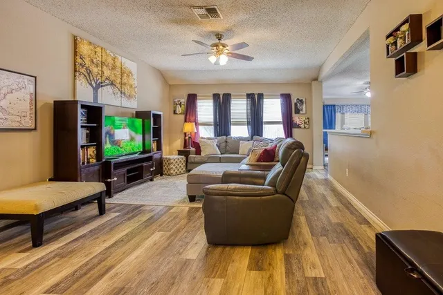 a kitchen with stainless steel appliances kitchen island granite countertop a sink a stove counter space and cabinets