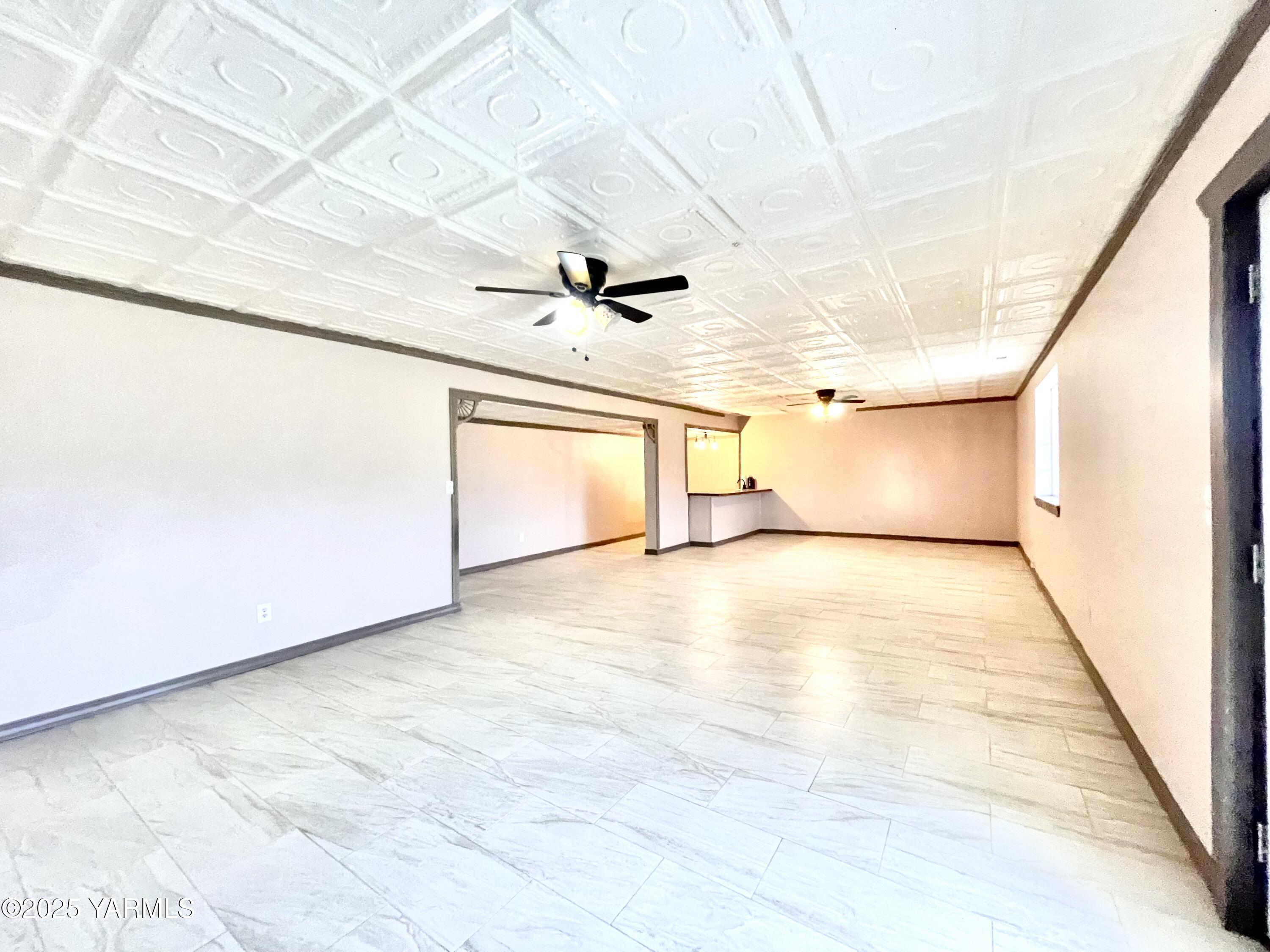 13010 Wide Hollow Road Yakima, WA 98908 - Photo 11 of 19 a view of a livingroom with wooden floor and a ceiling fan