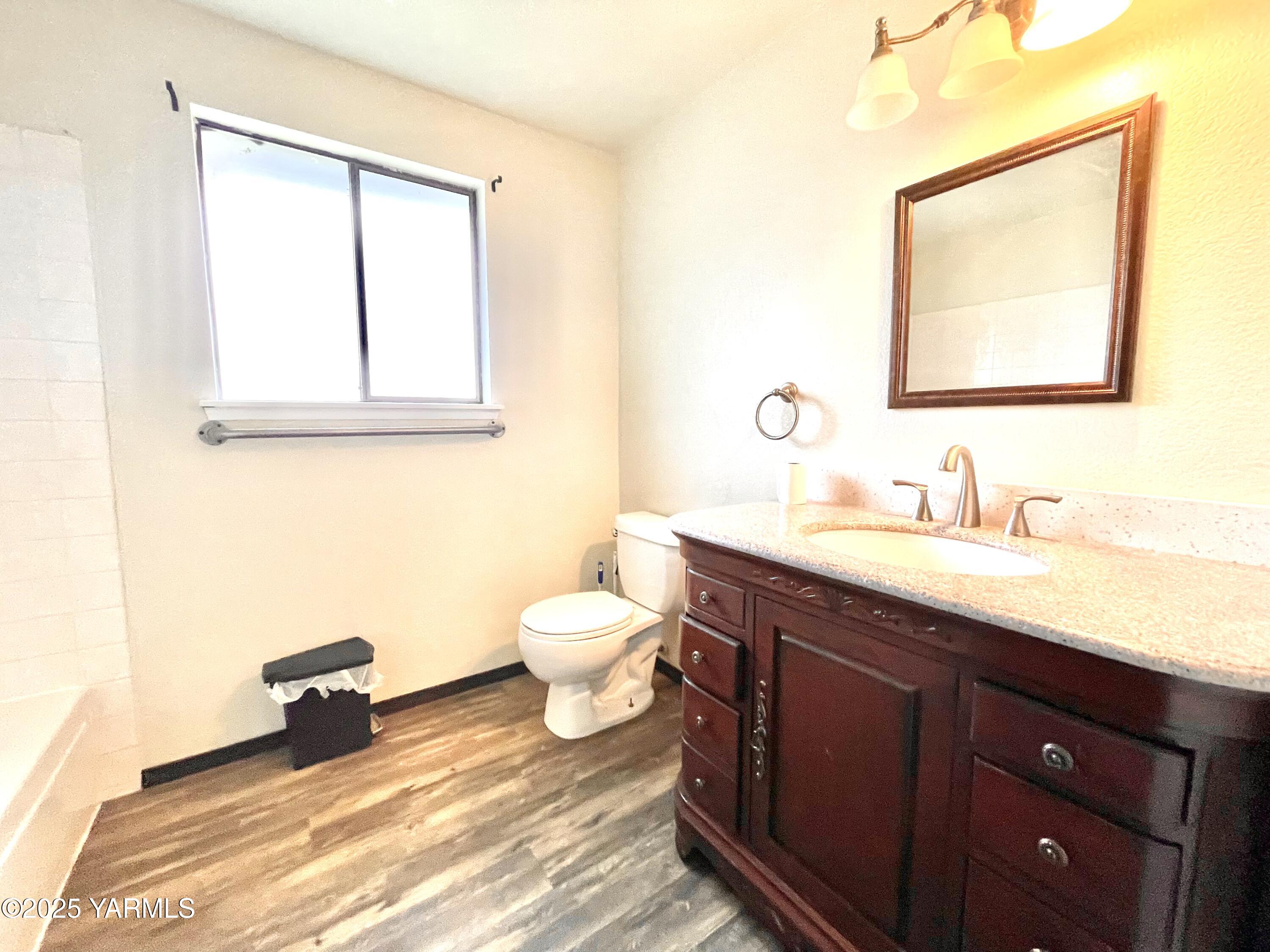13010 Wide Hollow Road Yakima, WA 98908 - Photo 13 of 19 a bathroom with a toilet sink double vanity and mirror