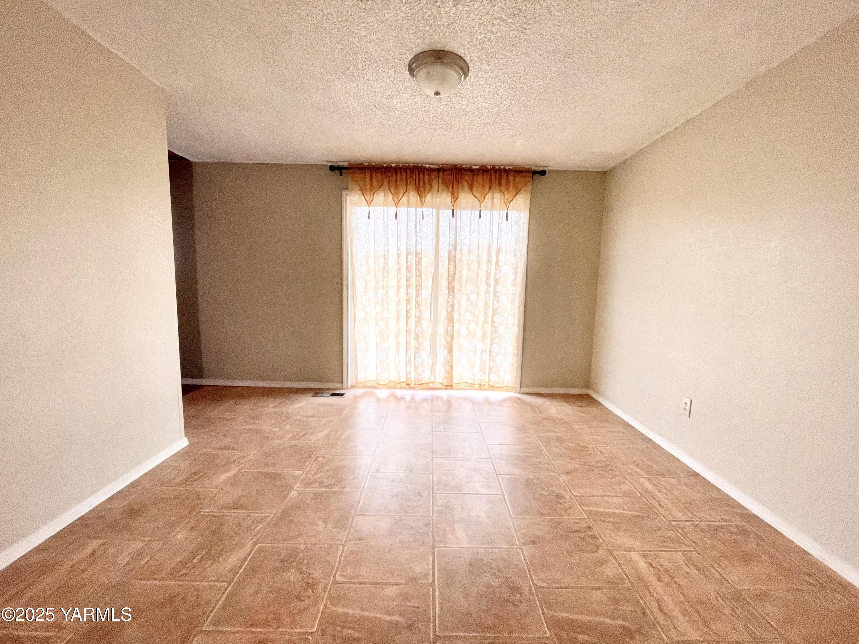 13010 Wide Hollow Road Yakima, WA 98908 - Photo 6 of 19 a view of an empty room with a window