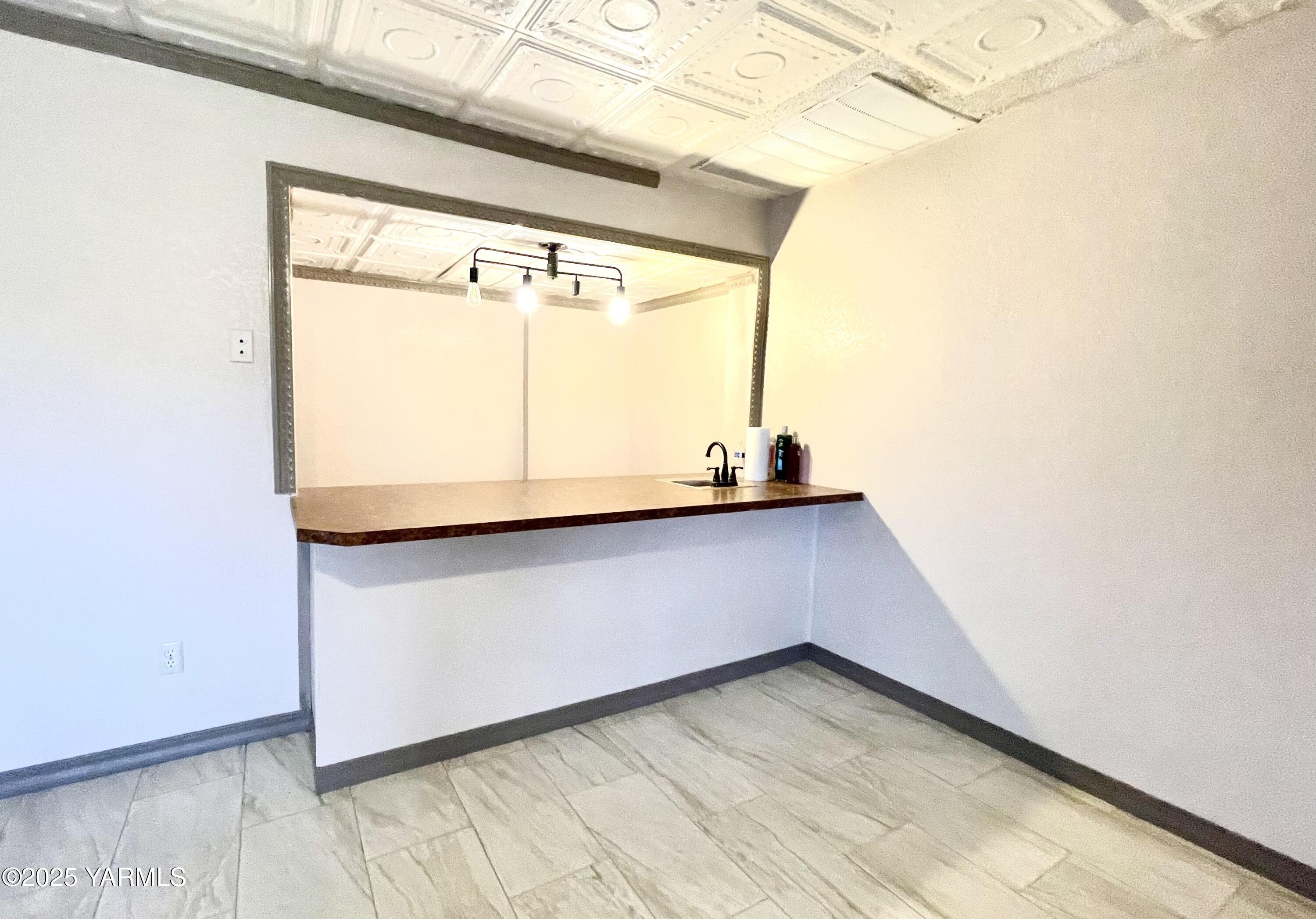 13010 Wide Hollow Road Yakima, WA 98908 - Photo 10 of 19 a view of an empty room with wooden floor and a window