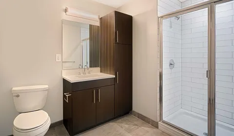 a bathroom with a sink toilet and shower
