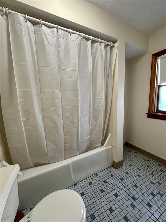 5 Rifle Court, Unit 5 Watertown, MA 02472 - Photo 6 of 14 a bathroom with a shower curtain and sink