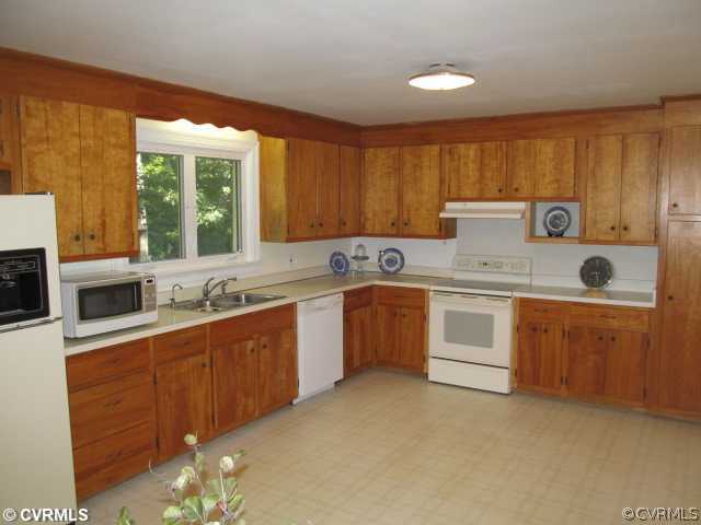2710 Salisbury Road Midlothian, VA 23113 - Photo 5 of 12 a kitchen with a stove sink and cabinets