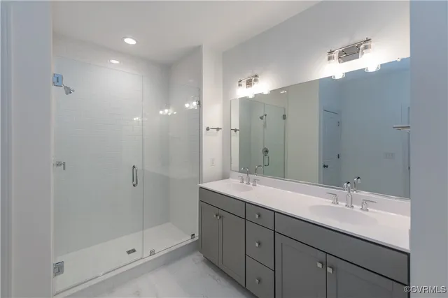 a bathroom with a shower sink double and mirror