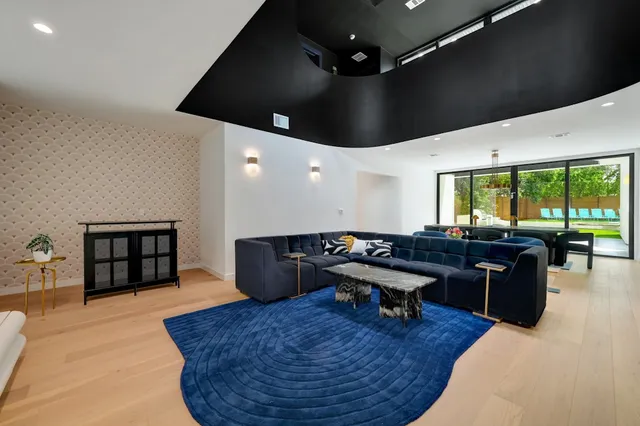 a dining room with furniture a chandelier and wooden floor