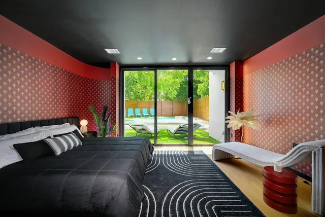 a bathroom with a double vanity sink a large mirror and a bathtub