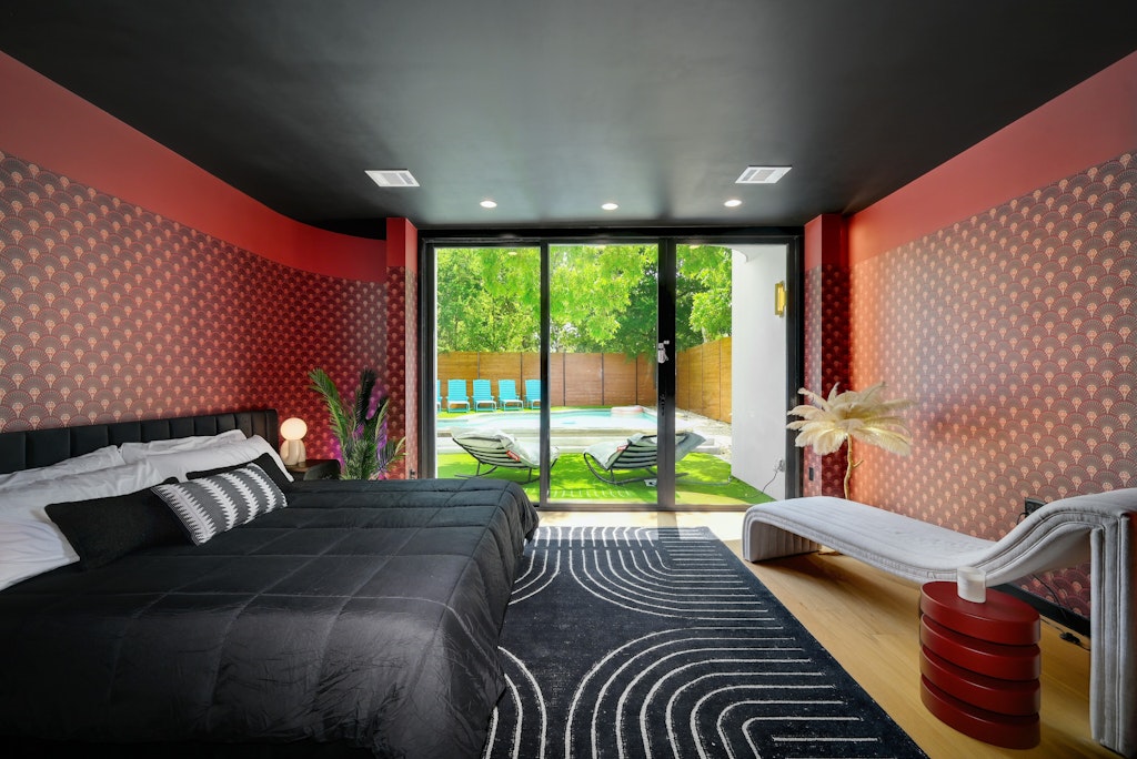 7809 Woodrow Avenue Austin, TX 78757 - Photo 15 of 40 a bedroom with a bed and a large window