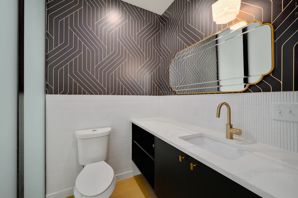 7809 Woodrow Avenue Austin, TX 78757 - Photo 21 of 40 a bathroom with a sink a toilet and mirror