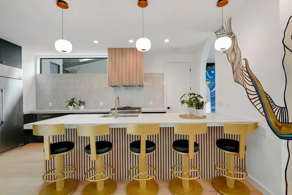 a kitchen with stainless steel appliances granite countertop a sink a stove and wooden floor