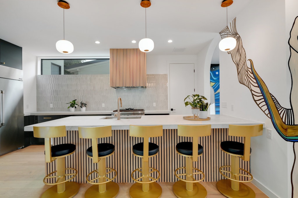7809 Woodrow Avenue Austin, TX 78757 - Photo 4 of 40 a kitchen with stainless steel appliances granite countertop a stove a sink a refrigerator a dining table and chairs