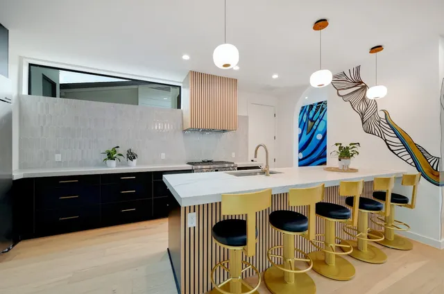 a kitchen with a sink stove and cabinets