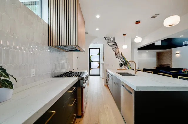 a kitchen with a sink stove and cabinets