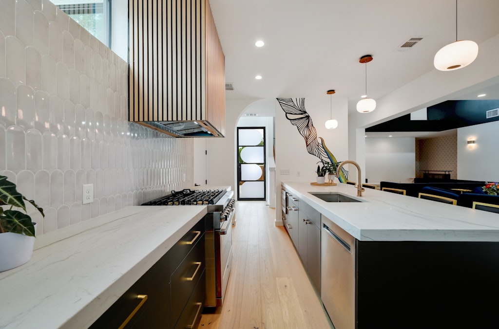 7809 Woodrow Avenue Austin, TX 78757 - Photo 6 of 40 a kitchen with a sink stove and cabinets