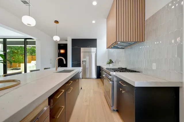 a kitchen with a refrigerator and a sink