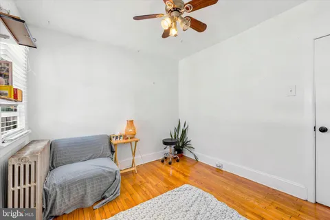 a room with a couch and wooden floor