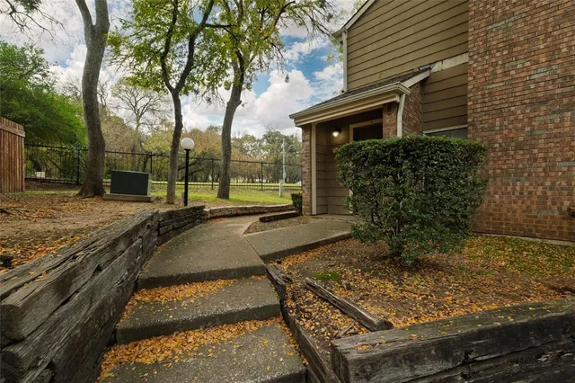 a view of a backyard with wooden fence