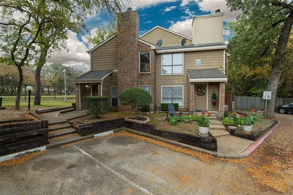 a view of a house with backyard and sitting area