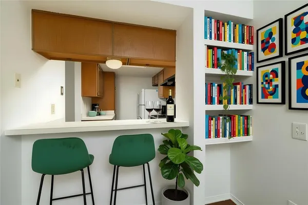 a living room with furniture and a book shelf