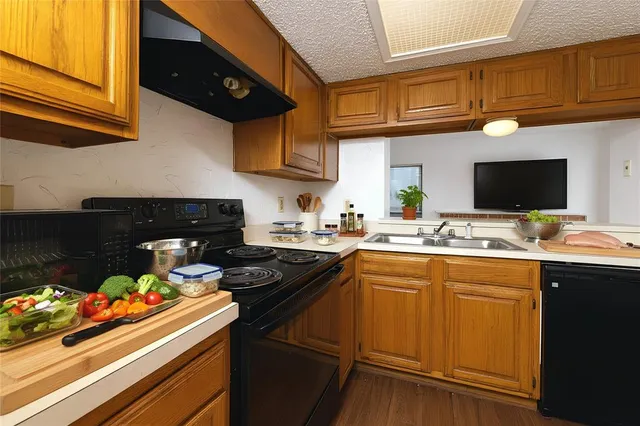 a kitchen with a sink cabinets and appliances