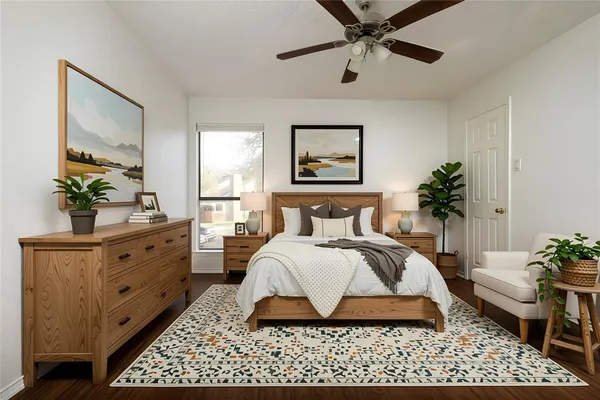 a spacious bedroom with a bed and a potted plant