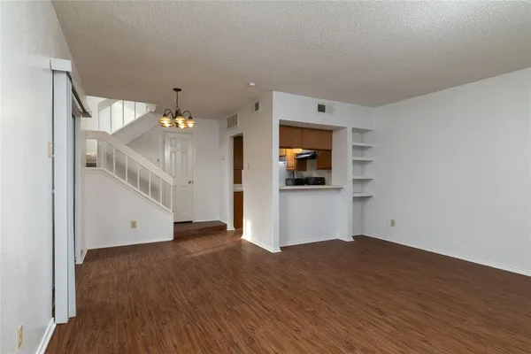a view of a kitchen with wooden floor