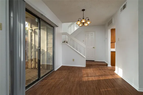 wooden floor in an empty room with a windows