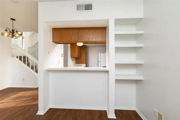 a view of an entryway with wooden floor