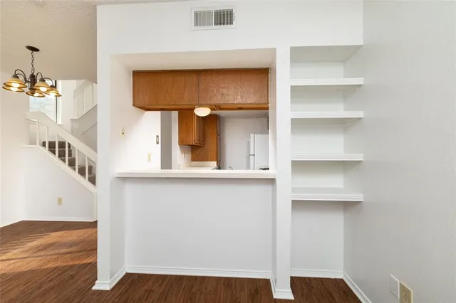 a view of an entryway with wooden floor