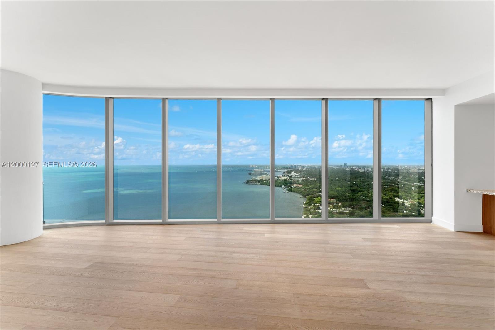 175 Southeast 25th Road, Unit 3602 Miami, FL 33129 - Photo 18 of 25 a view of lot of an empty room with wooden floor and a floor to ceiling window