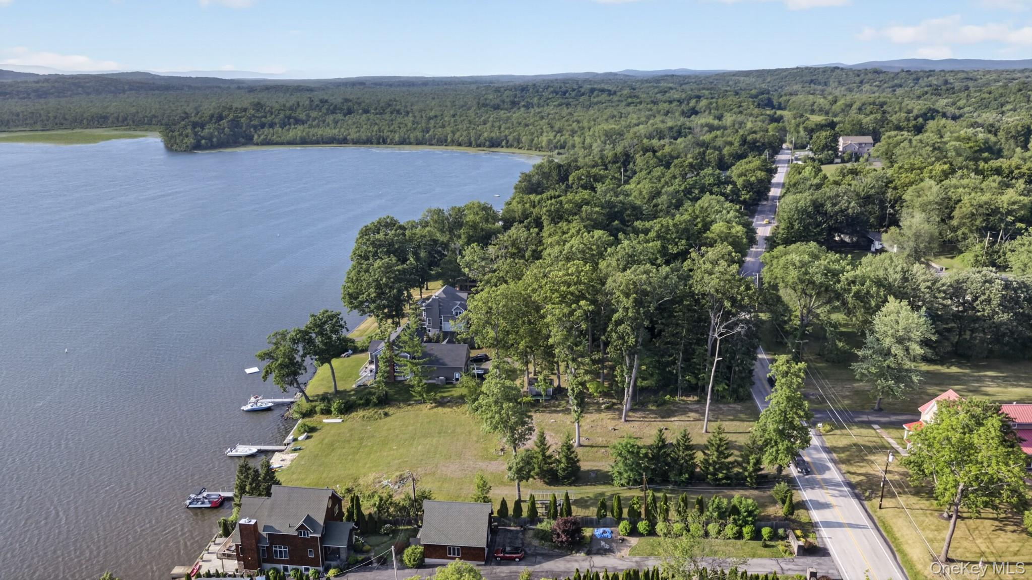 355 Lakeside Road Newburgh, NY 12550 - Photo 10 of 14 Expansive waterfront property featuring a substantial lakefront, private docks, and lush green lawns