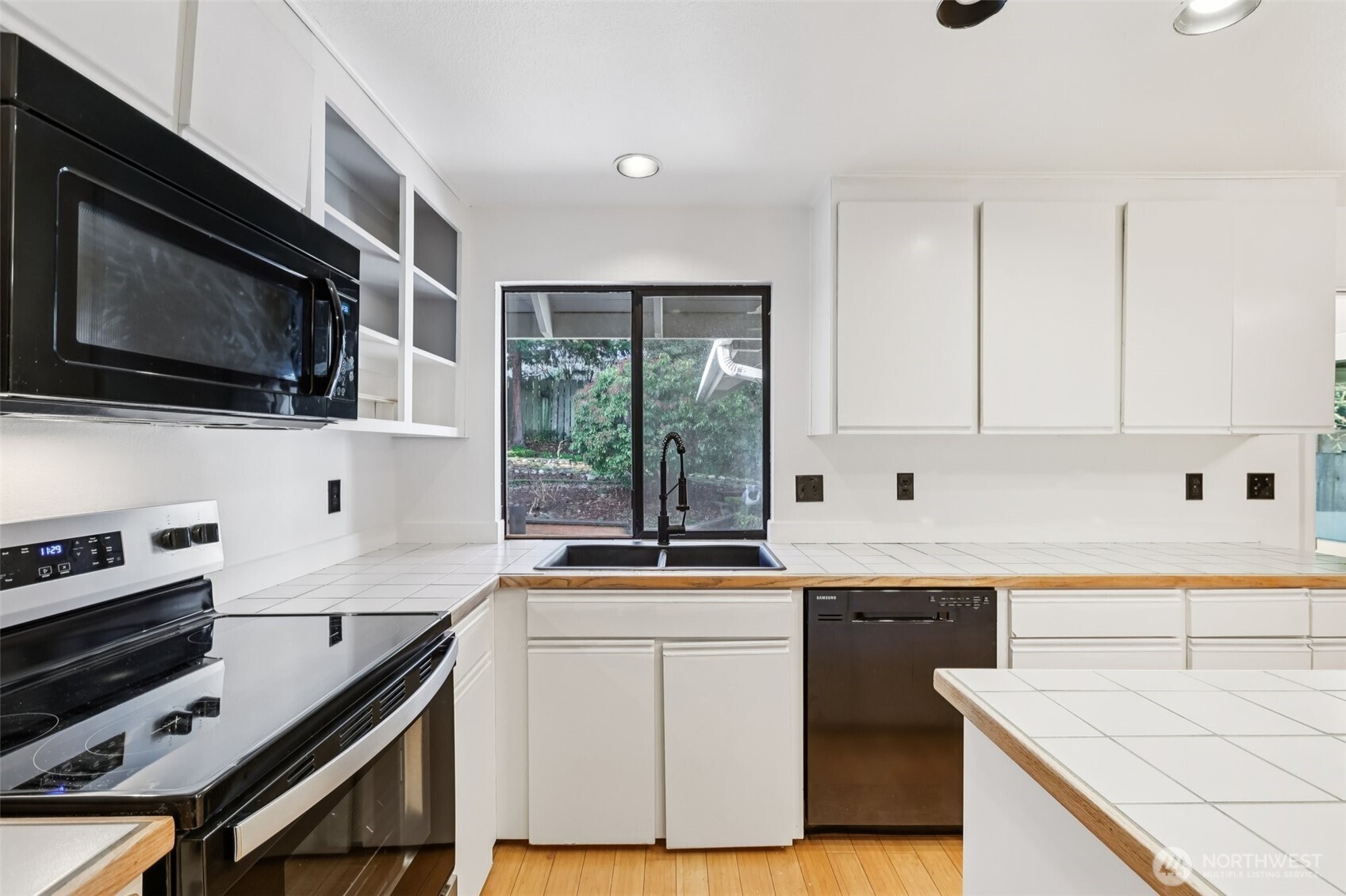 32229 2nd Avenue Southwest Federal Way, WA 98023 - Photo 9 of 40 a kitchen with a sink stove top oven and microwave