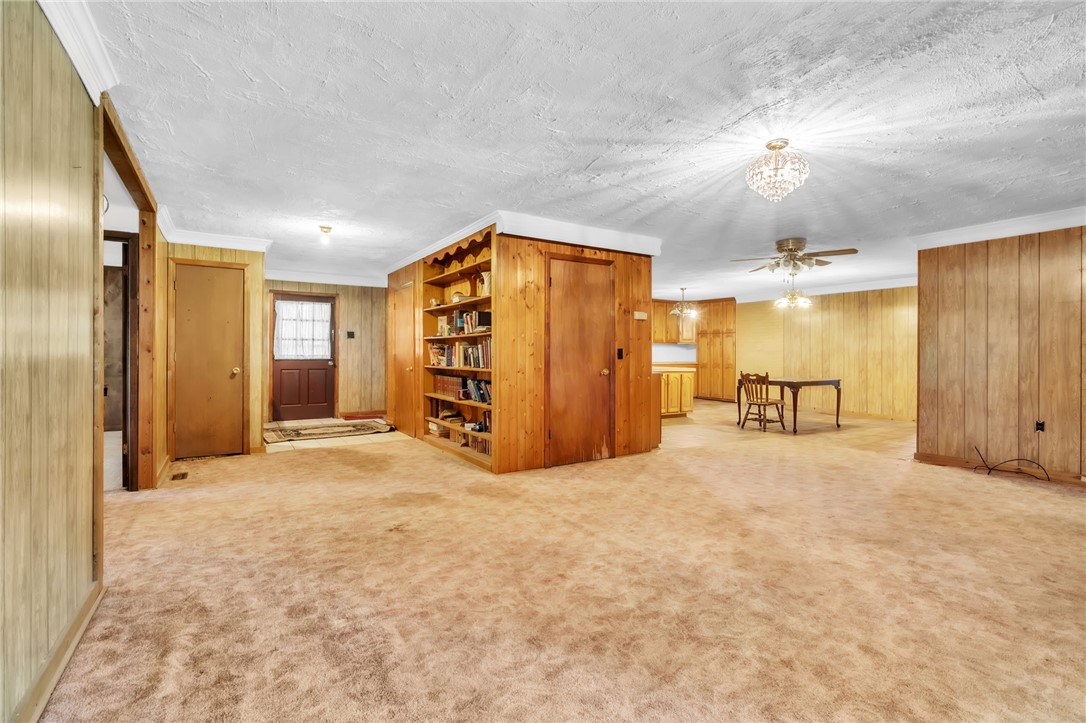 602 Harper Road Pendleton, SC 29670 - Photo 5 of 32 Natural wood paneling and built-in shelving define this versatile open space.