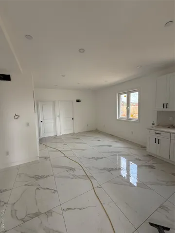 a kitchen with granite countertop a sink and cabinets