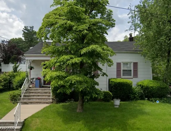a view of a house with a yard and plants