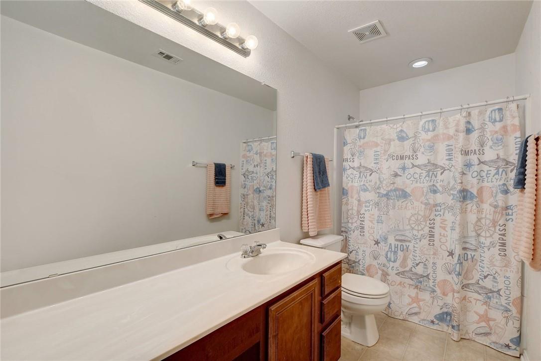 356 Matthews Kyle, TX 78640 - Photo 17 of 30 A neatly appointed bathroom features a spacious vanity and ample mirror, ready for daily routines.