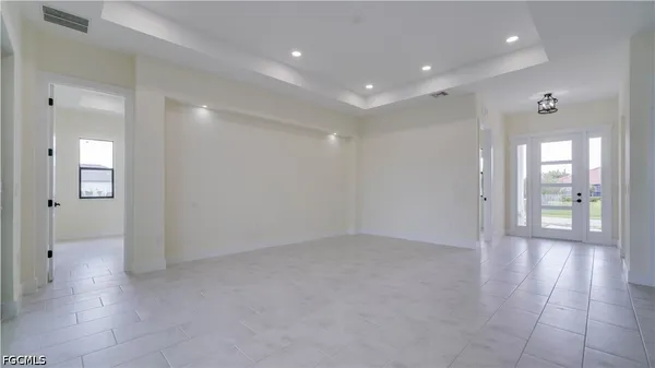 a view of an empty room with a kitchen