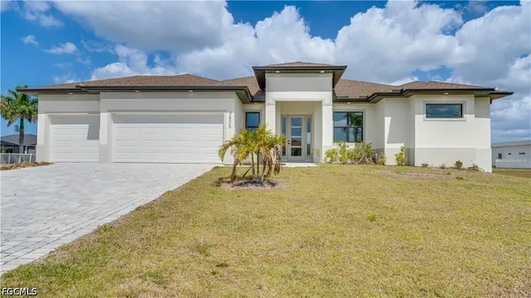 a front view of a house with a yard