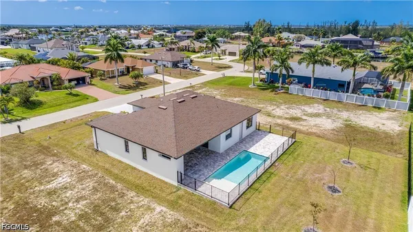 an aerial view of residential houses with outdoor space and seating area