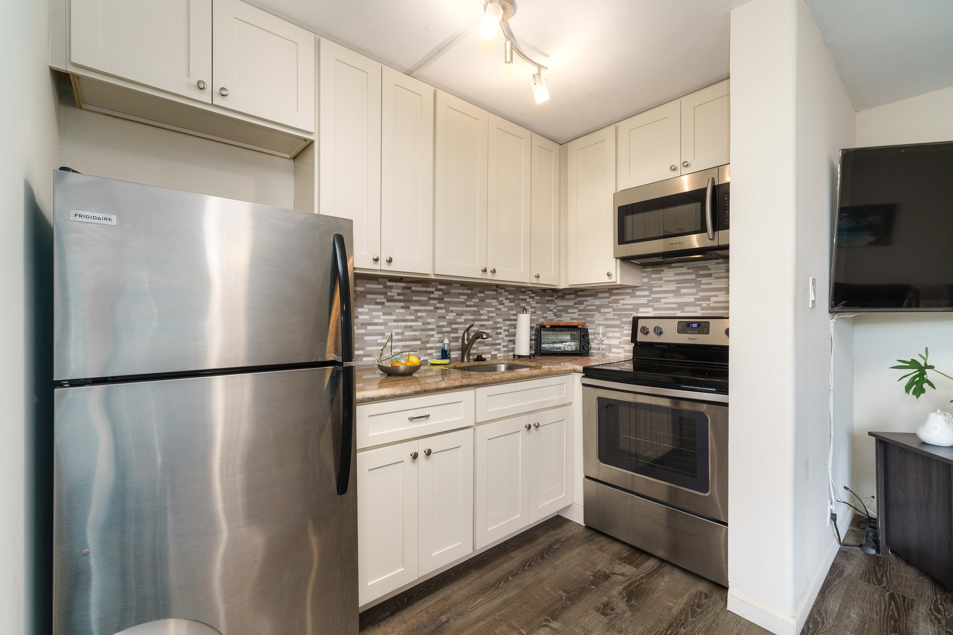 3660 Lower Honoapiilani Road, Unit 111 Lahaina, HI 96761 - Photo 1 of 28 a white refrigerator freezer sitting in a kitchen